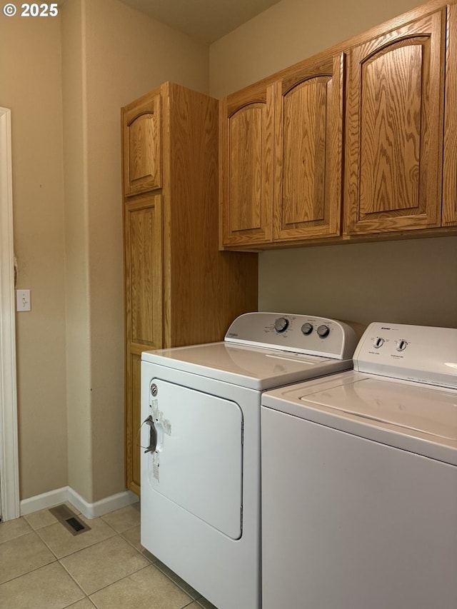 1922 Kapela Ct, Sutherlin, OR 97479 - laundry room with washer and clothes dryer, light tile patterned floors, cabinet space, and baseboards