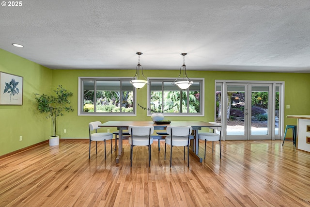 4729 SE Concord Rd, Milwaukie, OR 97267 - dining space featuring a textured ceiling, plenty of natural light, light wood-style floors, and baseboards