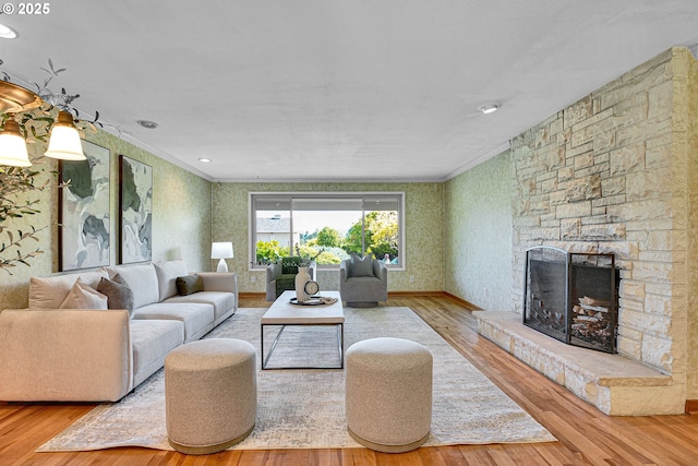 4729 SE Concord Rd, Milwaukie, OR 97267 - living area featuring crown molding, wood finished floors, wallpapered walls, and a stone fireplace