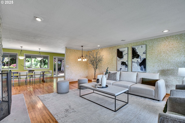 4729 SE Concord Rd, Milwaukie, OR 97267 - living area with wallpapered walls, a textured ceiling, a chandelier, wood-type flooring, and baseboards