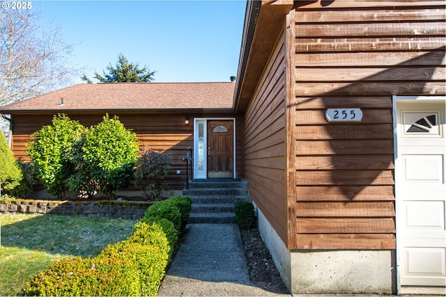 view of exterior entry with a garage