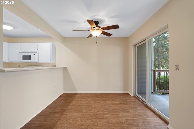 7145 SW Sagert St Unit 103, Tualatin, OR 97062 - unfurnished dining area featuring wood finished floors and ceiling fan
