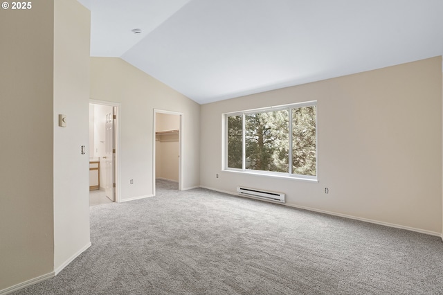 7145 SW Sagert St Unit 103, Tualatin, OR 97062 - spare room featuring a baseboard radiator, carpet flooring, and vaulted ceiling