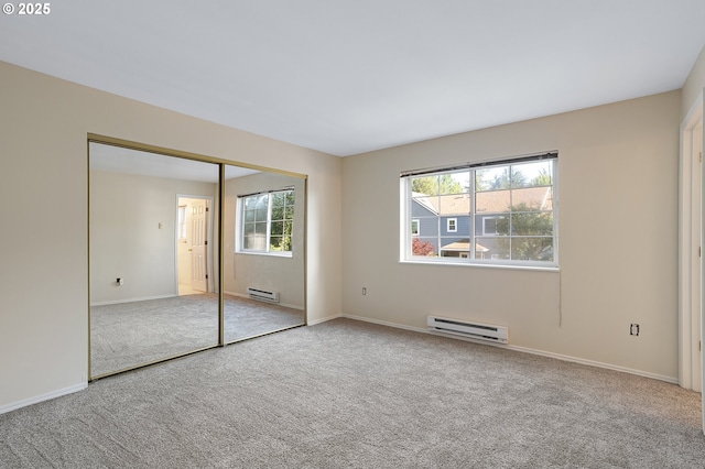 7145 SW Sagert St Unit 103, Tualatin, OR 97062 - unfurnished bedroom featuring a baseboard radiator, carpet floors, and a closet