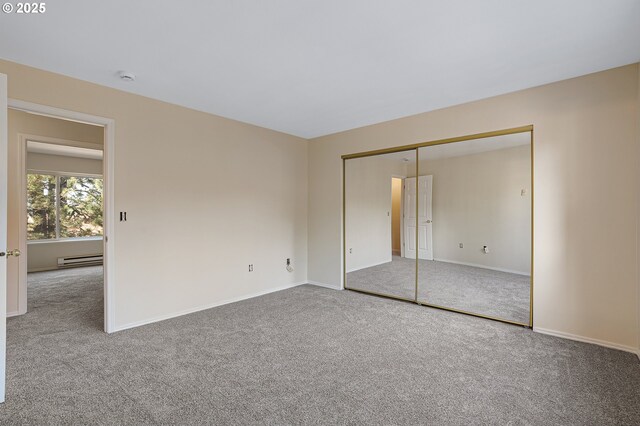 7145 SW Sagert St Unit 103, Tualatin, OR 97062 - unfurnished bedroom with carpet, a baseboard radiator, and a closet