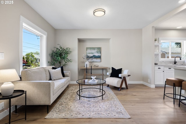 living room with light wood finished floors and baseboards