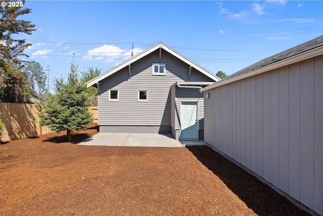 back of house with fence