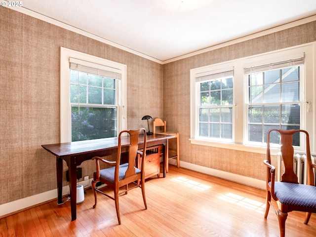 office space featuring light wood-style floors, baseboards, wallpapered walls, and a healthy amount of sunlight
