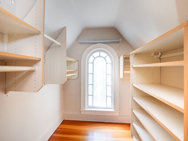 spacious closet with wood finished floors and lofted ceiling