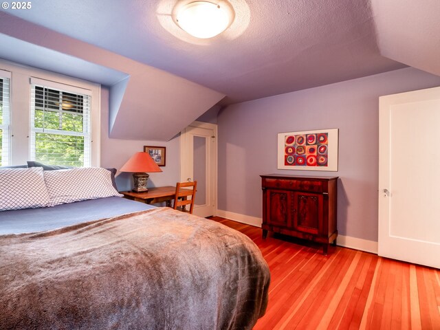 bedroom with light wood-style floors and baseboards