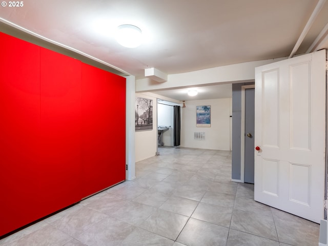 hallway with tile patterned floors and visible vents