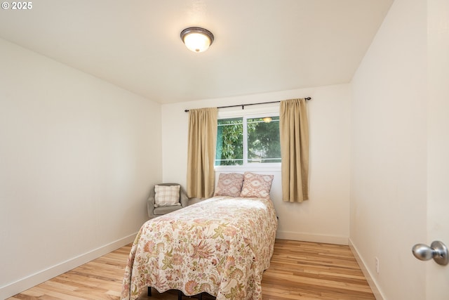 bedroom with wood finished floors and baseboards