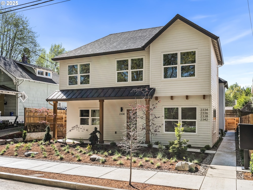2342 N Kilpatrick St Unit 4, Portland, OR 97217 - modern inspired farmhouse with fence, a standing seam roof, covered porch, and metal roof