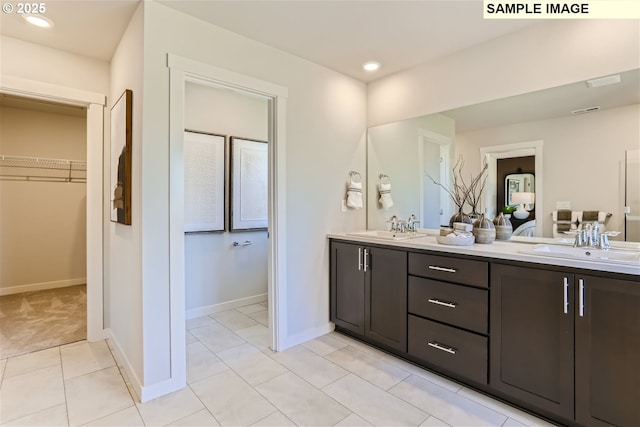 23870 SW Vermillion Dr, Tualatin, OR 97062 - full bathroom featuring double vanity, a walk in closet, baseboards, tile patterned flooring, and recessed lighting