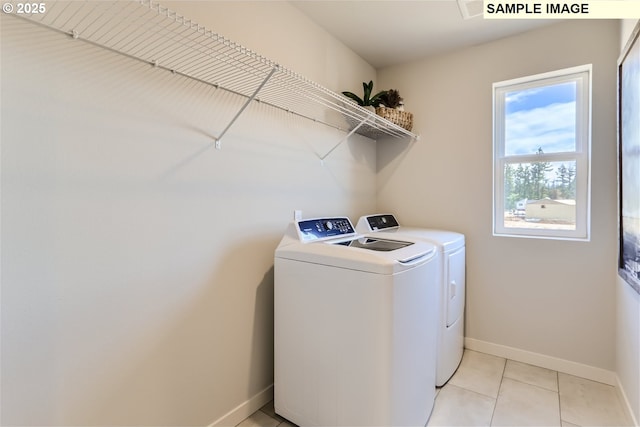 23870 SW Vermillion Dr, Tualatin, OR 97062 - laundry area with washing machine and clothes dryer, baseboards, and light tile patterned flooring
