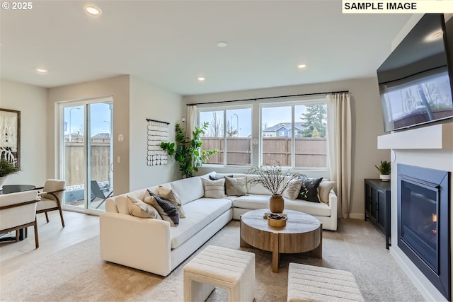 23870 SW Vermillion Dr, Tualatin, OR 97062 - living area with healthy amount of natural light, recessed lighting, and a glass covered fireplace