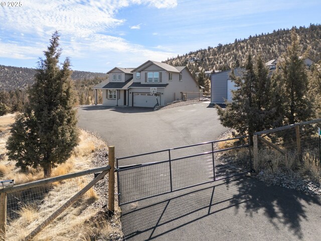 view of street featuring driveway and a gate