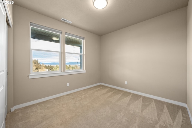 7220 SE Night Hawk Ct, Prineville, OR 97754 - spare room with baseboards, visible vents, and light colored carpet