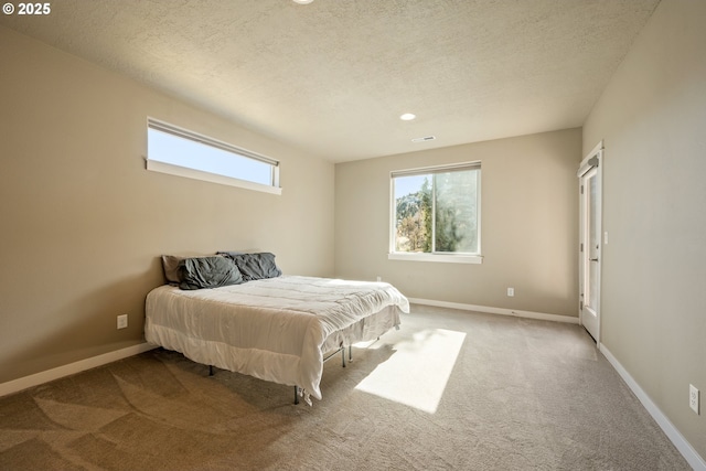 7220 SE Night Hawk Ct, Prineville, OR 97754 - carpeted bedroom with visible vents, a textured ceiling, and baseboards