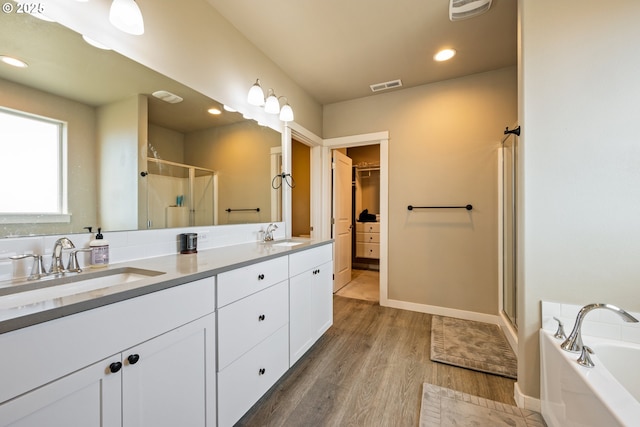 7220 SE Night Hawk Ct, Prineville, OR 97754 - full bath with visible vents, a sink, a shower stall, and wood finished floors