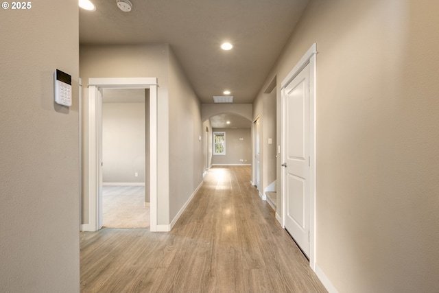 7220 SE Night Hawk Ct, Prineville, OR 97754 - hallway featuring arched walkways, light wood-style flooring, baseboards, and recessed lighting