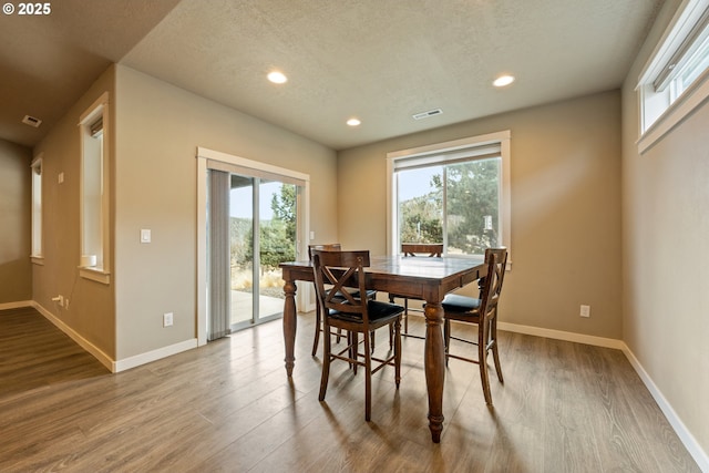 7220 SE Night Hawk Ct, Prineville, OR 97754 - dining area with baseboards, wood finished floors, and a healthy amount of sunlight