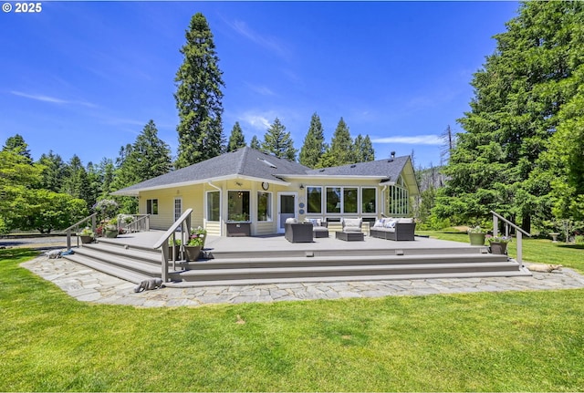 back of house featuring a lawn, a wooden deck, and outdoor lounge area