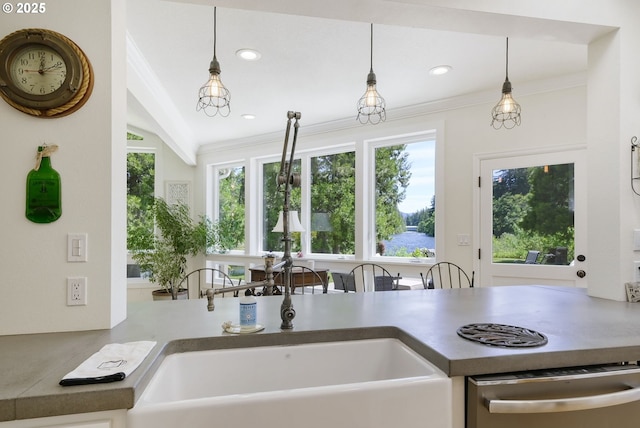 kitchen featuring sink, dishwasher, hanging light fixtures, and lofted ceiling