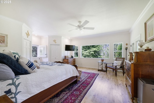 bedroom with light hardwood / wood-style floors, a closet, ceiling fan, and ornamental molding