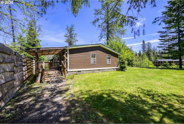 rear view of property featuring a lawn