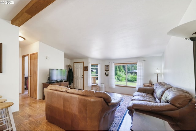 living room with light hardwood / wood-style flooring and beam ceiling