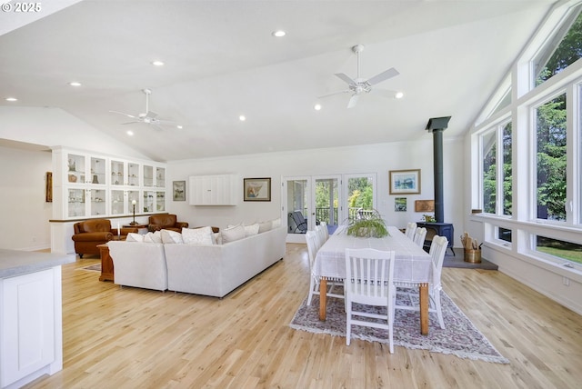 living room with ceiling fan, french doors, light hardwood / wood-style floors, and lofted ceiling