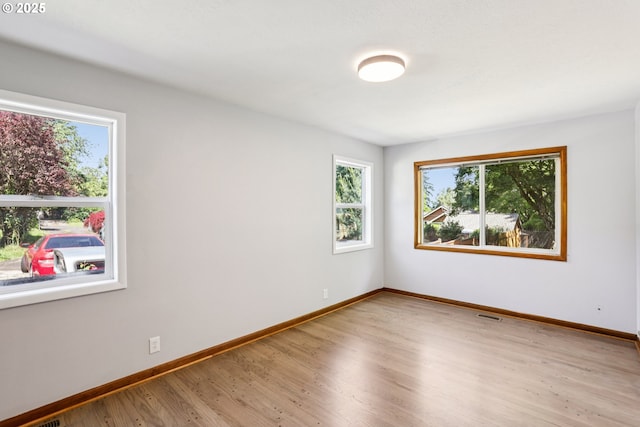 10925 NE Skidmore St, Portland, OR 97220 - empty room featuring baseboards and wood finished floors
