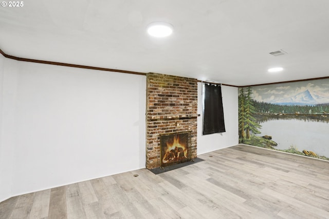 10925 NE Skidmore St, Portland, OR 97220 - unfurnished living room with crown molding, wood finished floors, a fireplace, and a water view