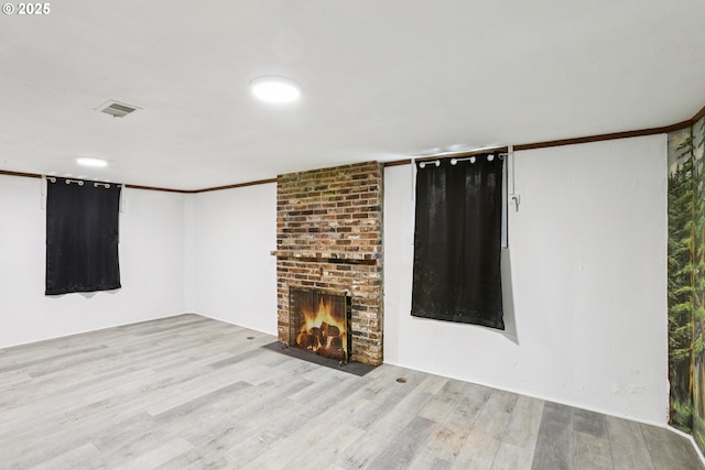 10925 NE Skidmore St, Portland, OR 97220 - unfurnished living room with wood finished floors and a brick fireplace