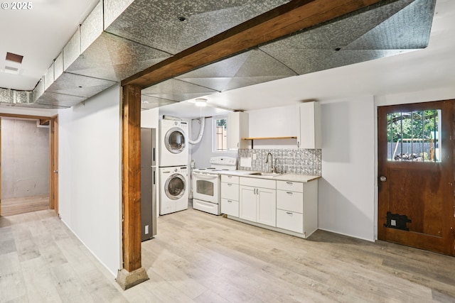 10925 NE Skidmore St, Portland, OR 97220 - laundry room featuring estacked washer and dryer, light wood-style flooring, and healthy amount of natural light