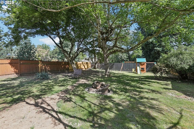 10925 NE Skidmore St, Portland, OR 97220 - fenced backyard with a playground and a fire pit