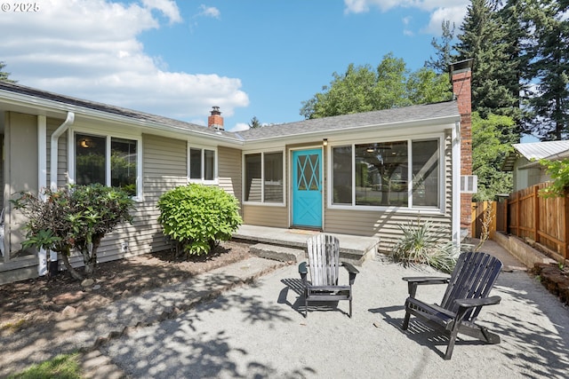 10925 NE Skidmore St, Portland, OR 97220 - back of property with a chimney and a patio area
