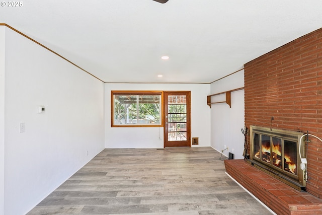 10925 NE Skidmore St, Portland, OR 97220 - unfurnished living room featuring wood finished floors, a brick fireplace, and recessed lighting