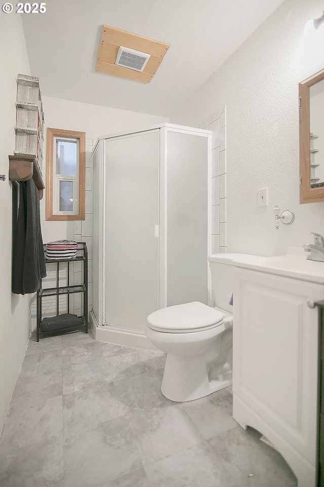 bathroom with vanity, toilet, and walk in shower