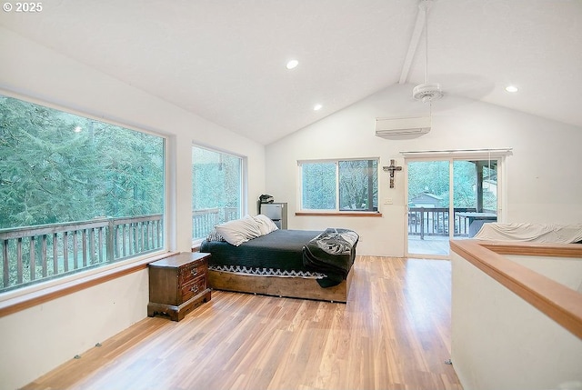 bedroom featuring access to exterior, a wall mounted air conditioner, wood-type flooring, lofted ceiling, and multiple windows