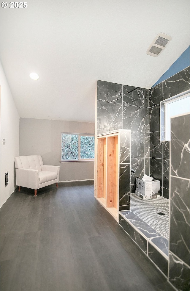 interior space featuring vaulted ceiling and dark wood-type flooring