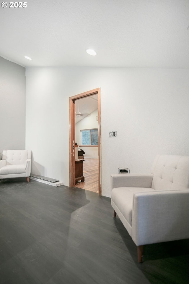 living area with hardwood / wood-style floors and vaulted ceiling