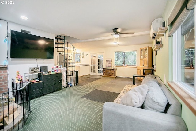 carpeted living room with ceiling fan, an AC wall unit, and french doors