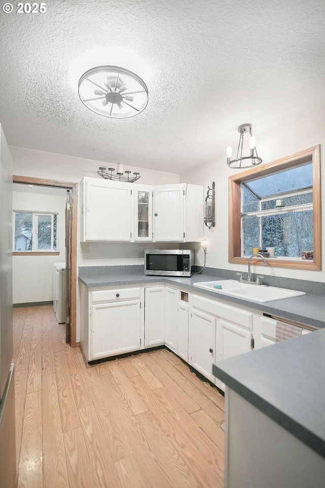 kitchen featuring white cabinetry, sink, ceiling fan, and a textured ceiling