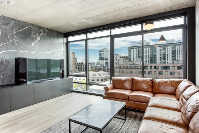 1410 NW Kearney St Unit 721, Portland, OR 97209 - living room with expansive windows, a healthy amount of sunlight, and wood finished floors