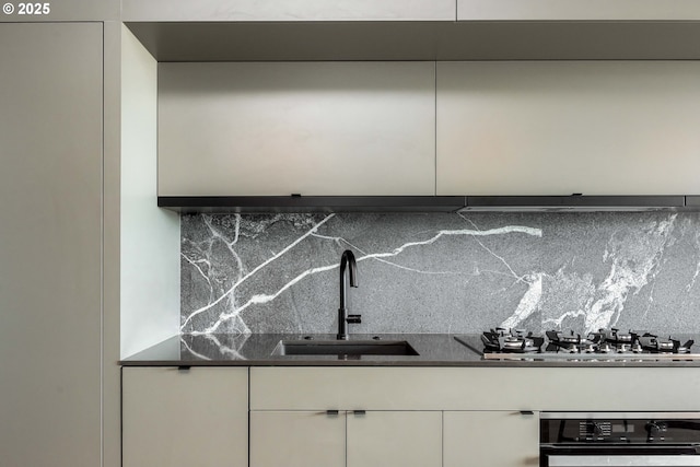 1410 NW Kearney St Unit 721, Portland, OR 97209 - kitchen featuring tasteful backsplash, a sink, stainless steel gas stovetop, white cabinets, and wall oven