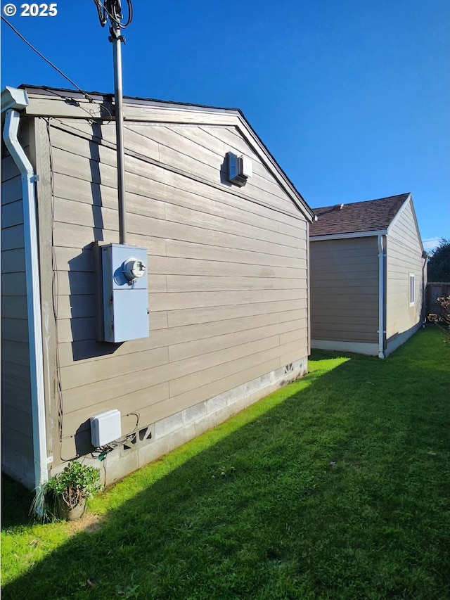 view of home's exterior featuring an outdoor structure, a lawn, and crawl space