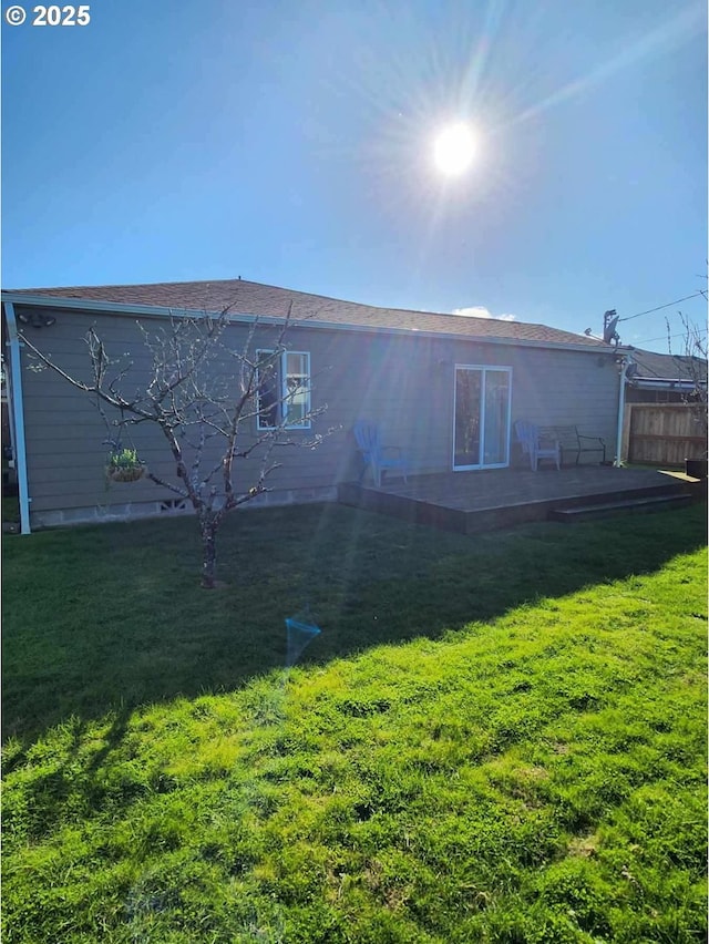 rear view of property with a yard and a patio area