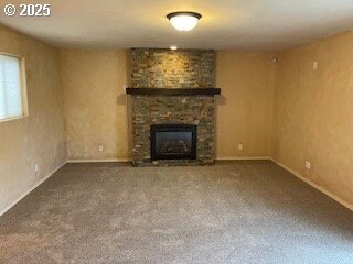 kitchen with sink, light colored carpet, stainless steel dishwasher, and kitchen peninsula